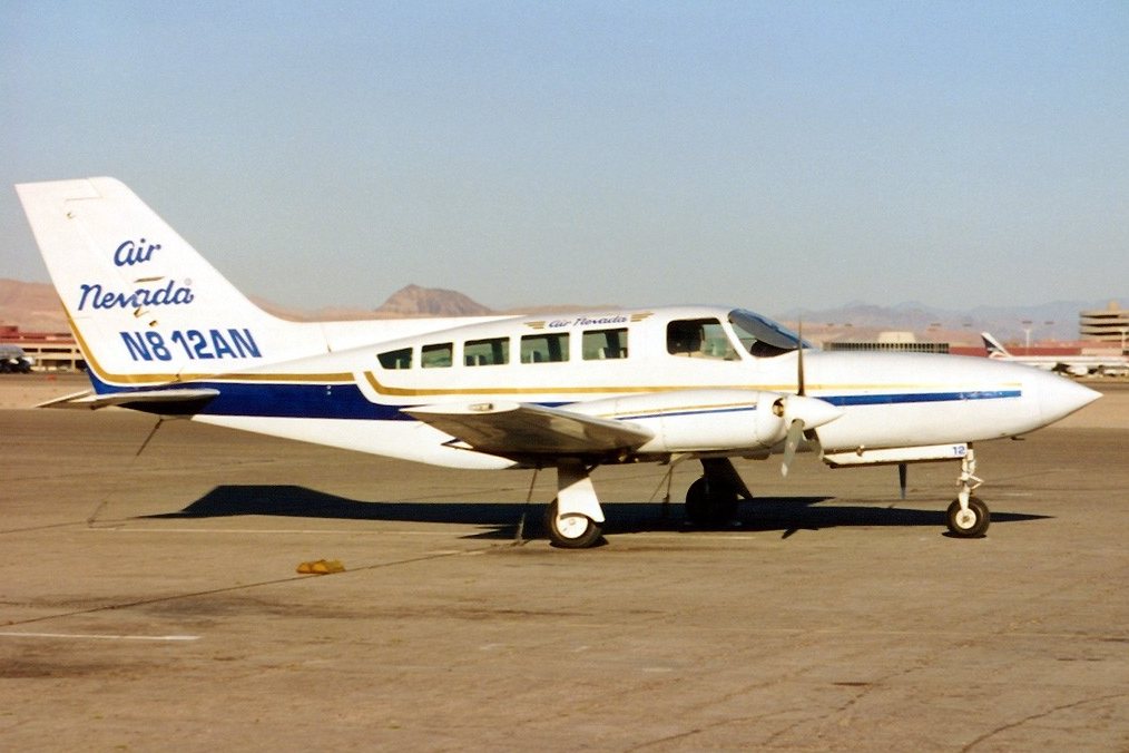 Air Nevada Cessna 402 N812AN on the ramp with desert mountains behind