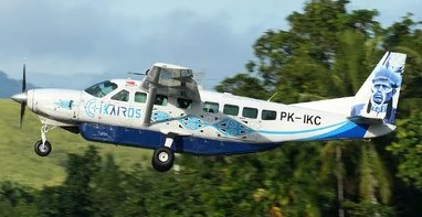 PT Ikairos Air Services Cessna Grand Caravan PK-IKC taking off over green hills