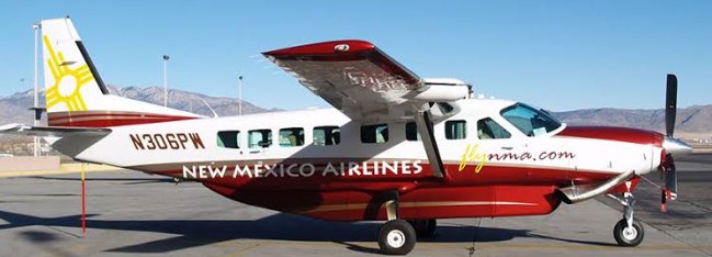 New Mexico Airlines Cessna Grand Caravan N306PW parked with mountains behind